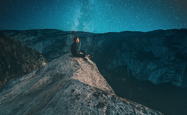 man sitting mountain stars millennial faith Christian theology