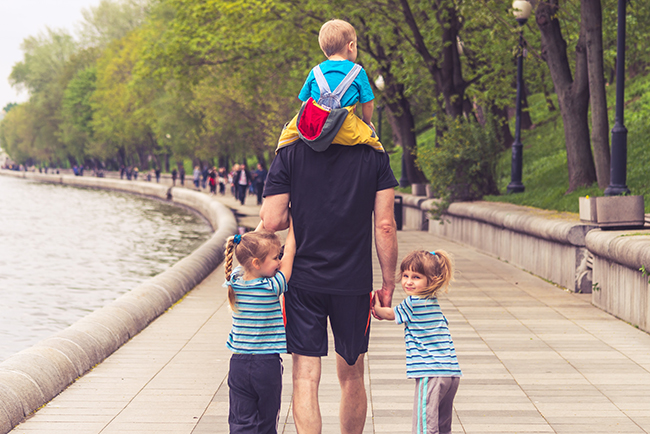 Father leading his children through a park - a father's faith