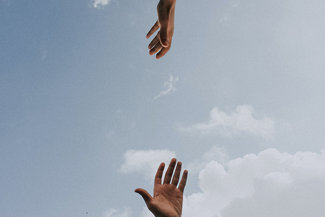 Hands reaching toward one another - How pastors can build healthy church relationships