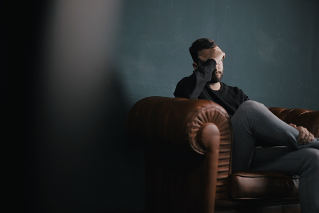 Stressed pastor sitting on couch - pastor stress