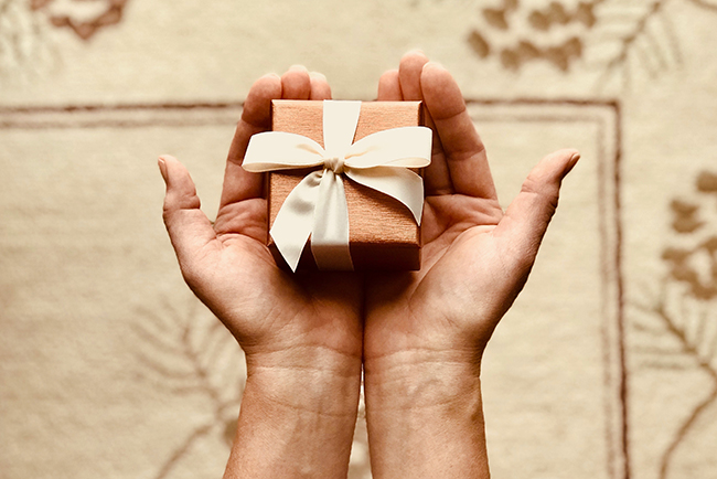 Hands holding small gift - What are spiritual gifts?