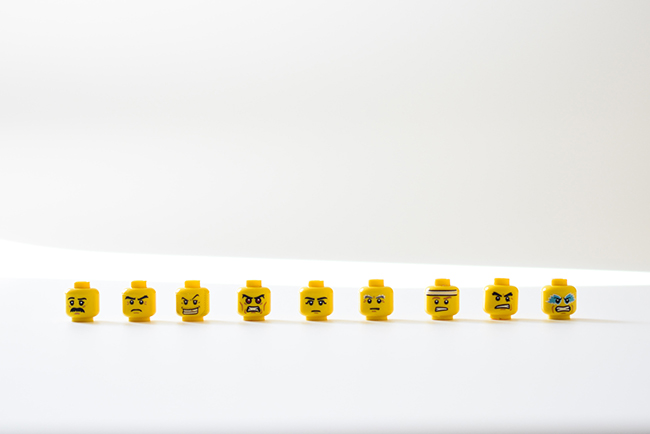 Lego heads in a line with various expressions - emotional intelligence