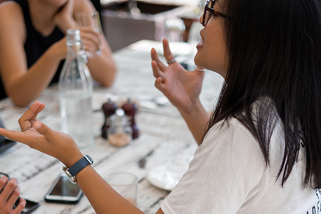 Woman having conversation at table with friends - plan for evangelism