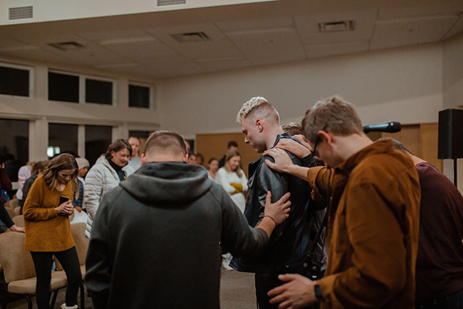 men praying together - being the church