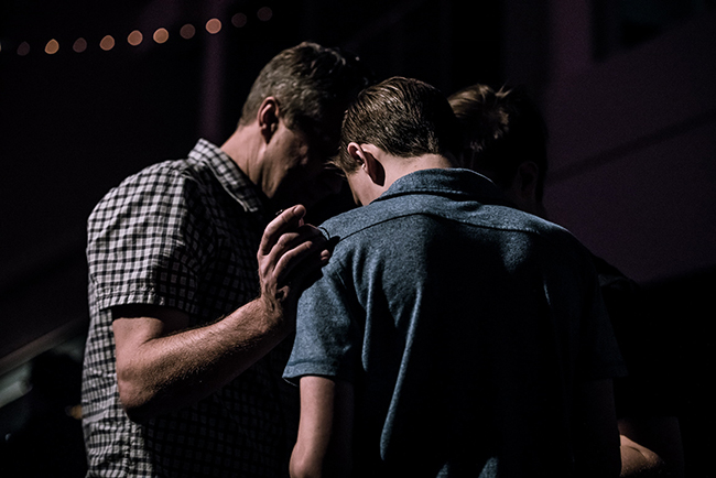 men in church praying together