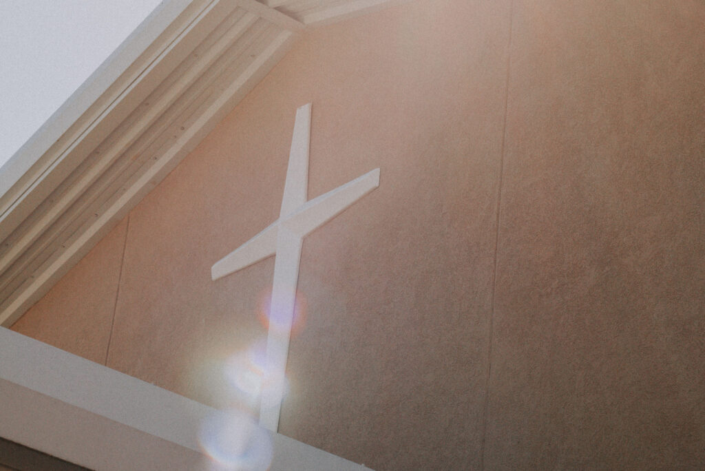 white cross on church building - church trust