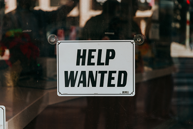 Help wanted sign on window - asking for volunteers