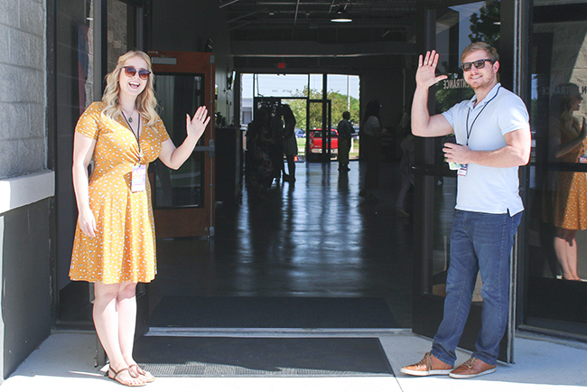Greeters waving at church entrance - serve in the church