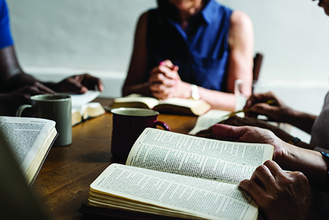 women studying their Bibles around a table - Ministry to women