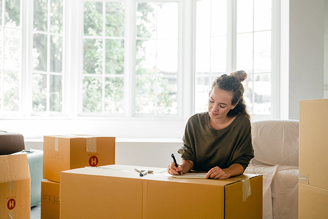 Woman packing boxes - how to find a church after you move