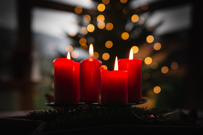 shallow focus picture of four red candles burning - what is Advent?