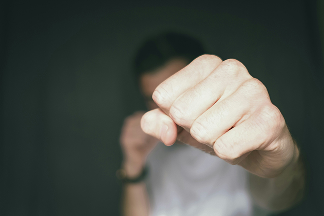 close up of fist positioned for a punch - five finger church communication strategy
